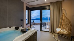 A modern bathroom with a bathtub, a glass shower, and a view of the outdoors.
