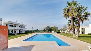 A rectangular swimming pool with a tiled edge, surrounded by a brick patio. - Pera Sea View With Pool by Homing (Silves)