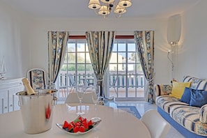 Enjoy a romantic dinner for two in this elegant room, complete with a dining area and sofa.