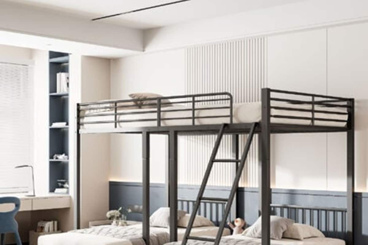 A bunk bed room with a desk and shelving.