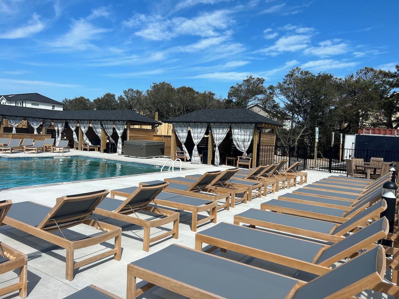 A poolside area with sun loungers and a pool.