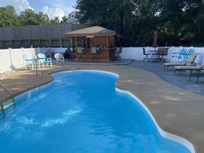 A swimming pool with a wooden deck and lounge chairs. - Private Pool, Tiki Bar, Beach & Sound Access (Kitty Hawk)