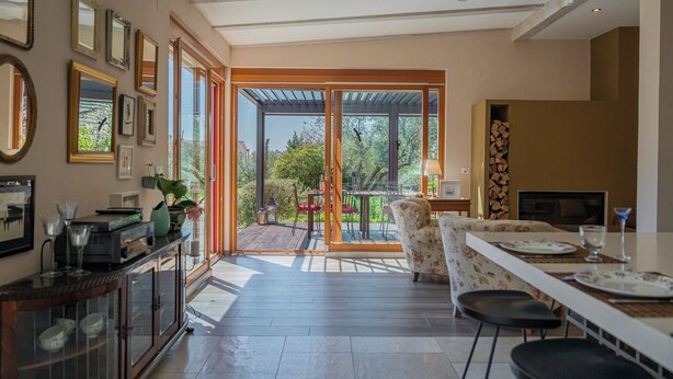 Una cocina amplia con comedor, ventanas grandes y vistas al exterior.