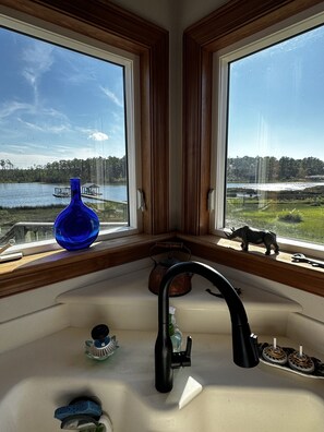 Enjoy a serene view of the lake and forest from the kitchen window.