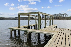 Stroll along the pier, taking in the serene views of the surrounding water and lush trees.