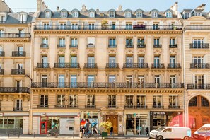 A multi-story building with a classic European architectural style, featuring ornate balconies and large windows.