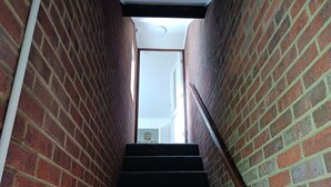 A brick staircase with a handrail, leading to an upper floor. - Cosy 1-bed Apartment in Swindon, Private Parking (Swindon)