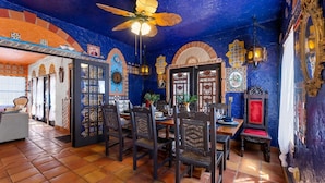 A dining area with a blue ceiling, tiled floor, and traditional decor. - The Gaudi House- Pool/Minutes to DNTN and Beach (St. Augustine)