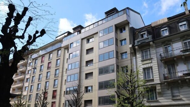 A multi-story building with a modern architectural style, featuring a flat roof and large windows. - Pérolles by Interhome (Freiburg)