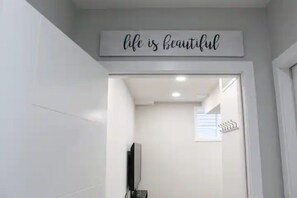 A bathroom with a sign above the mirror that reads "life is beautiful." - Forget ur worries in this spacious, light-filled, & serene legal basement suite (Calgary)