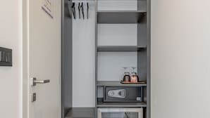 A compact storage unit with shelves, a microwave, and a small refrigerator.