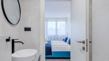 Habitación doble Deluxe, balcón | Baño | Regadera, regadera tipo lluvia, amenidades de baño ecológicas
