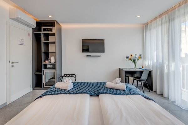 Deluxe Double Room, Balcony | In-room safe, individually decorated, individually furnished, desk