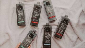 Six bottles of Ruby Care products on a white towel.