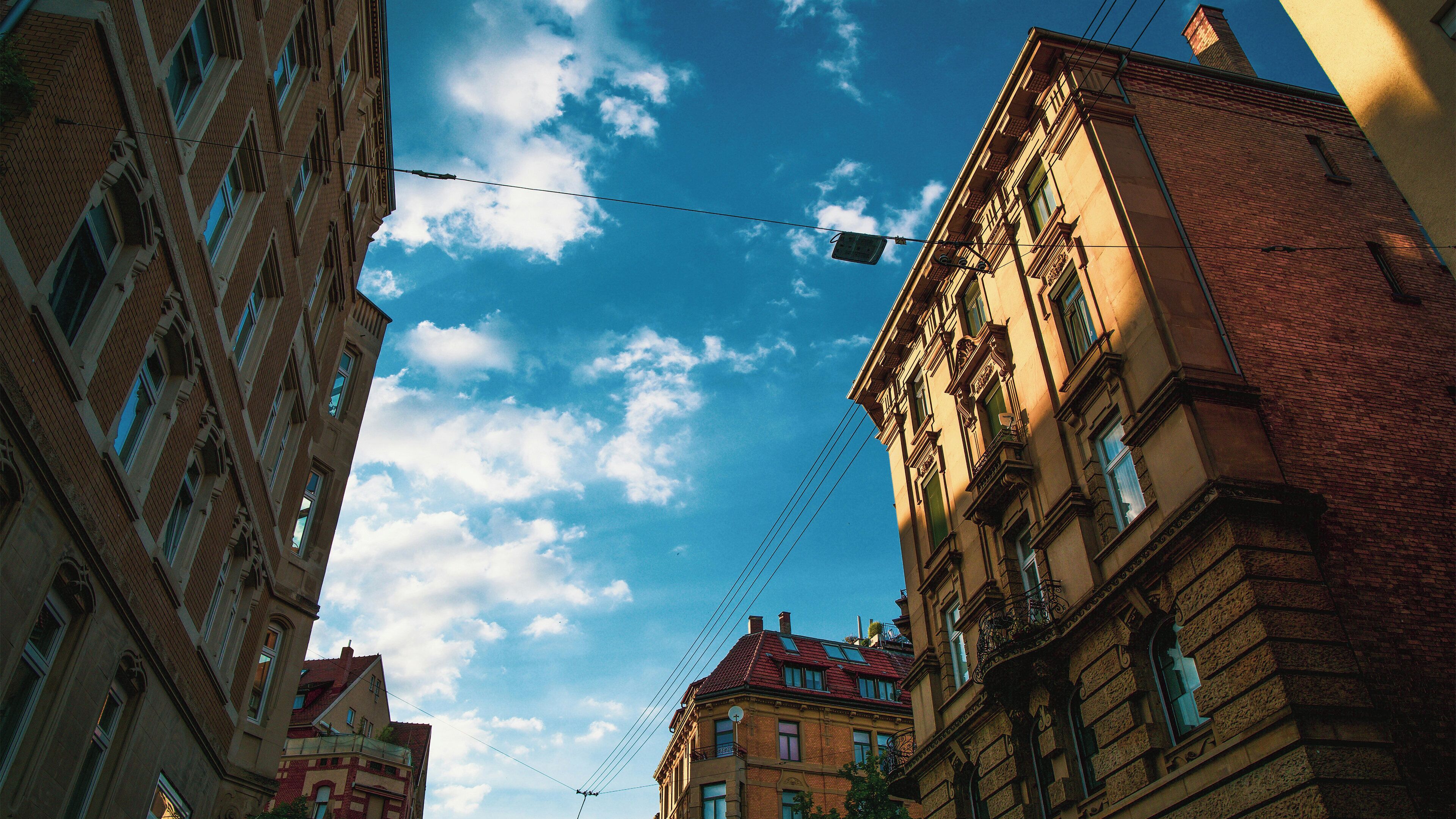 A multi-story building with a clear sky and clouds.