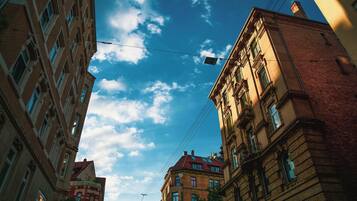 A multi-story building with a clear sky and clouds.