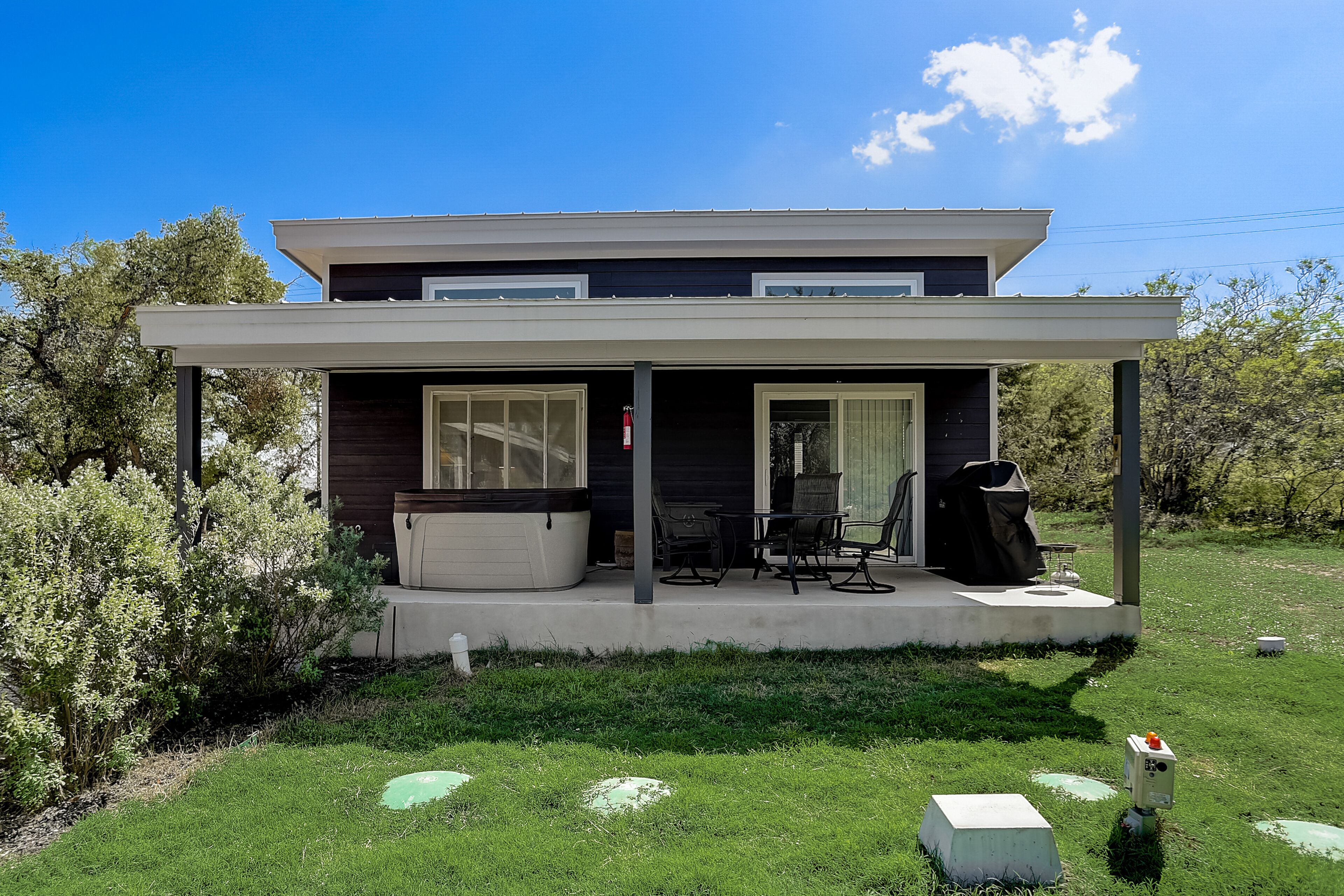 Dog-friendly home with private hot tub, porch, grill, AC, & W/D