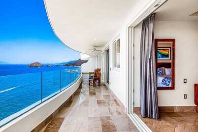 Oceanfront 9th-floor condo with balcony, water views & pool