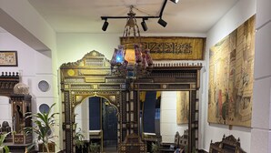 A traditional interior with ornate furniture, a patterned rug, and a large mirror reflecting the room. - Osiris pyramids view inn  (Giza)