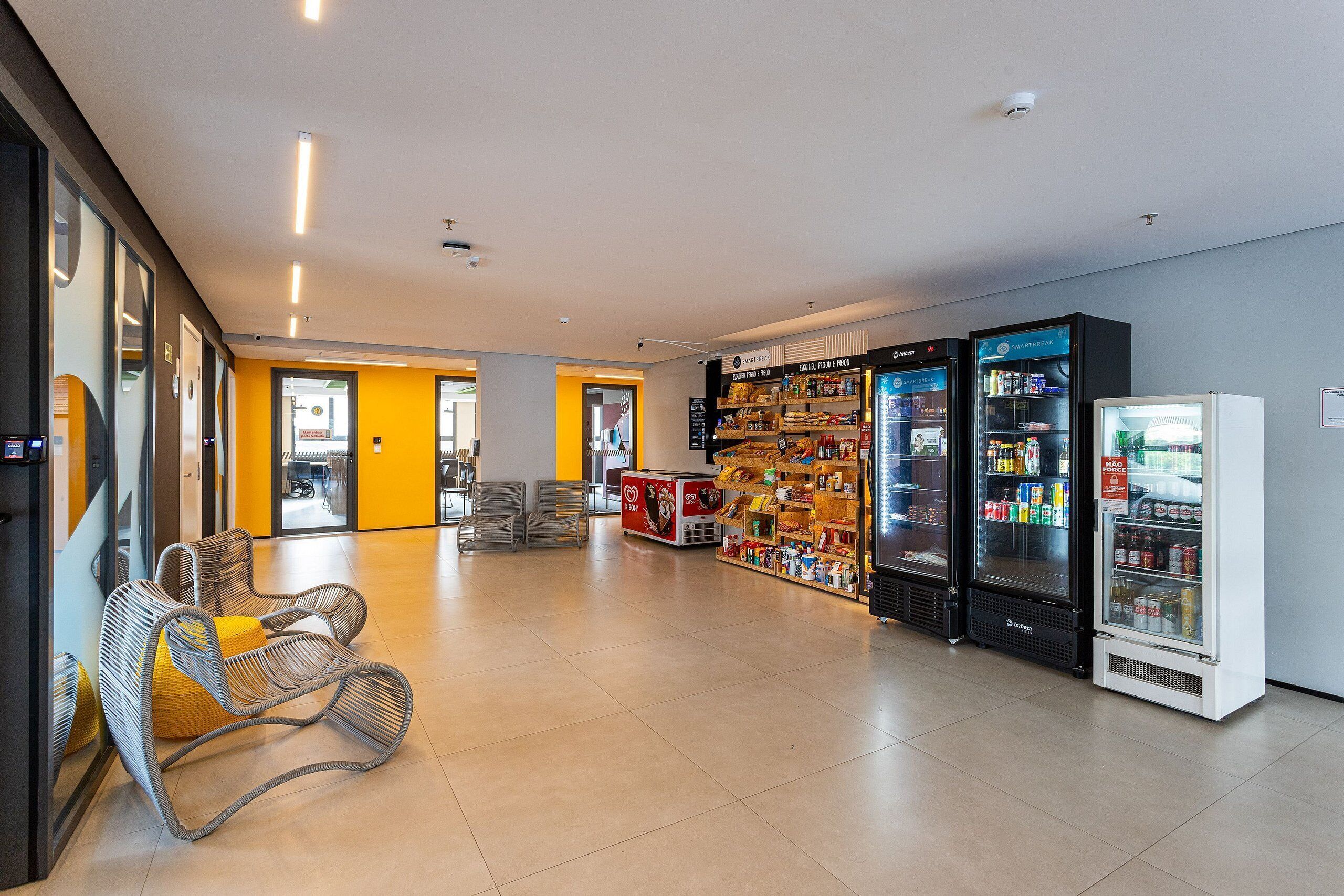 A spacious lobby with seating, vending machines, and a visible exit.