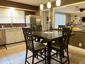 A modern kitchen with a dining area, featuring a large island, built-in appliances, and pendant lighting. - Ocean Dr Gem! Walk 2 Bay & Downtown. Spacious! (Corpus Christi)