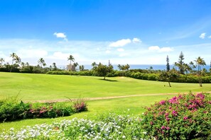 A golf course with a clear view of the ocean and palm trees in the background. - Kaanapali Plantation | Ocean View 3 BR | Car Incl. w/ 6+ Nights | KPL-46 by KBM (Lahaina)