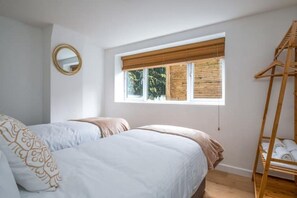 Relax in a serene bedroom with a large bed and a loft-style sleeping area.