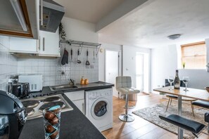 Enjoy meals in the kitchen with an oven, sink, and dishwasher, and dine at the table with comfortable seating.