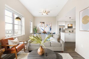 Relax in this stylish living space with a comfortable seating area, dining space, and modern kitchen.