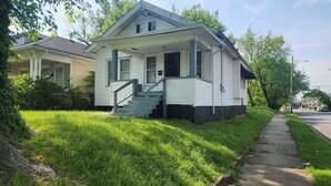 A single-story house with a front porch, a staircase leading to the entrance, and a well-maintained lawn. - Derby rental furnished 2BR, 1 full bath(shower/tub) house (Louisville)