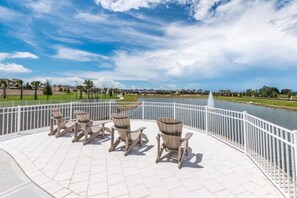 Relax in the serene outdoor seating area, surrounded by a fire pit and scenic views of the nearby water.