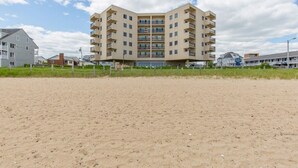 A multi-story building with a flat roof, located near a sandy area. - Seawatch Oceanview Unit 502 (Old Orchard Beach)