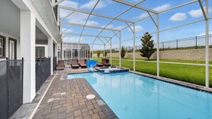 A covered outdoor swimming pool with lounge chairs and a hot tub. - Super 8BR Resort Pool Vacation Home Near Disney (Davenport)