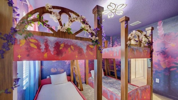 A bedroom with a bunk bed, a canopy bed, and a decorative archway. - Super 8BR Resort Pool Vacation Home Near Disney (Davenport)