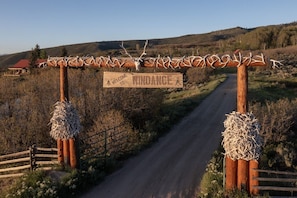 A wooden sign with antlers and the words 'WELCOME TO WINDANCE' on a rural road. - Windance Cabin, Private Beach on 750 Acres For You (Garfield County)