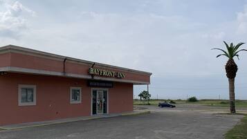 A building with a sign reading "Bayfront Inn" and a "Registration Office" sign.