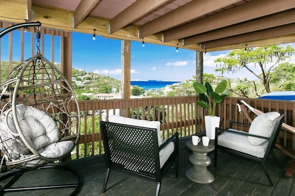 Relax on the deck with stunning ocean views and cozy seating. Perfect for a serene island getaway!