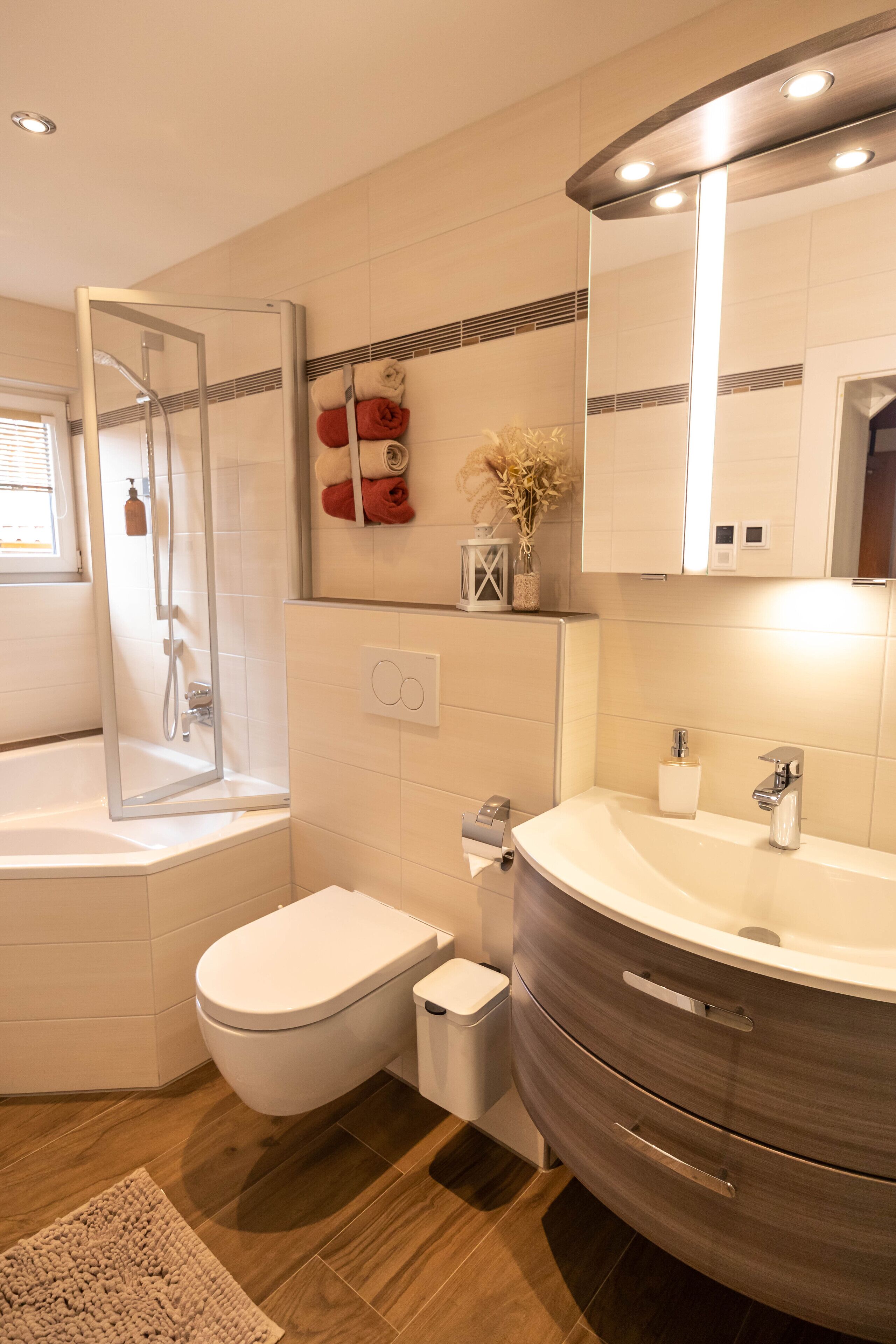 A modern bathroom with a glass-enclosed shower, a toilet, a sink, and a vanity.