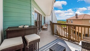 A balcony with wicker furniture and a view of the ocean. - La Mirage Condo 240 Beachfront Resort Condominiums with Private Boardwalk to Beach (Port Aransas)