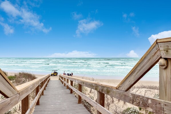 Walk along the boardwalk to the sandy beach, where the ocean awaits.