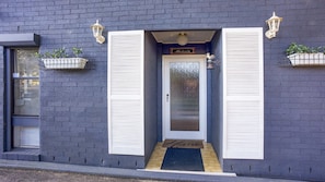 Welcome to Atlanta, where a charming entrance awaits with a white door, frosted glass panel, and decorative details.