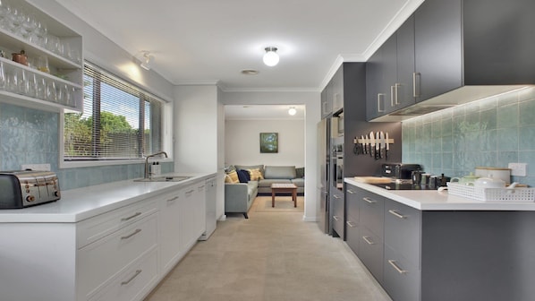 Enjoy a well-lit kitchen with an oven, large window, and comfortable seating area.