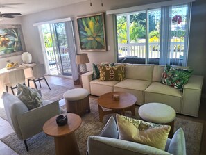A spacious living room with a sofa, armchairs, a coffee table, and a dining area with chairs and a table. - GORGEOUS RENTAL! Paradise In Old Time Florida at "The Dew Drop Ian" (Bokeelia)