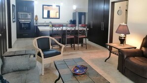 A compact living space with a kitchenette, dining area, and seating. - One bedroom apartment, quiet & relaxing atmosphere (Bucerias)