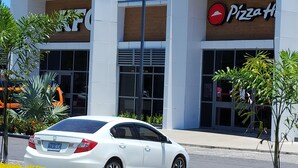 A Pizza Hut restaurant with a white facade and large windows. - PLAN YOUR GETAWAY UNDER THE SUN 
           Dazzle Key Suite (Saint Ann's Bay)