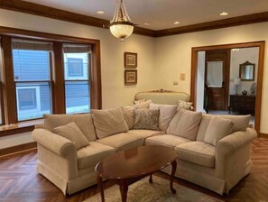 Relax in this inviting living room with a comfortable sofa, coffee table, and chandelier.