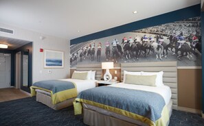 A hotel room with two beds, a large mural of a horse race, a nightstand, and a view of the ocean. - Derby City Gaming & Hotel - A Churchill Downs Property (Adults Only) (Louisville)