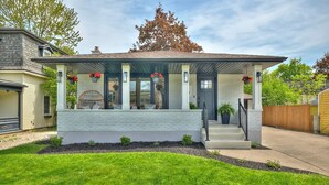 Une maison moderne à deux étages, dotée d’un porche abrité, de grandes fenêtres et d’une pelouse bien entretenue.