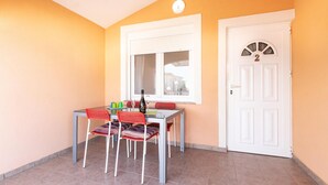A small room with a table and chairs, a window, and a door. - Amazing apartment in Vir with WiFi (Vir)