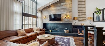 Modern retreat with wood-burning fireplace, hot tub access, and grill